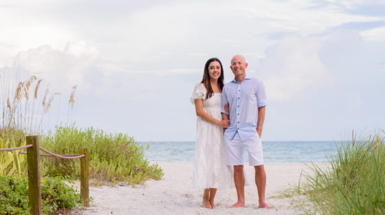 Two people standing on the beach