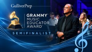 This graphic shows a man in a suit standing before a musical ensemble, announcing him as a Gulliver Prep Grammy Music Educator Award semifinalist.