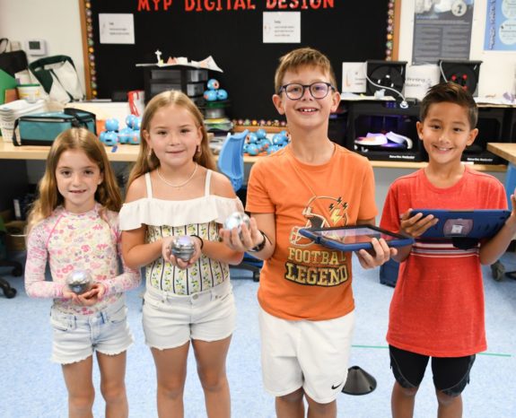 kids holding engineering tools at engineering camp