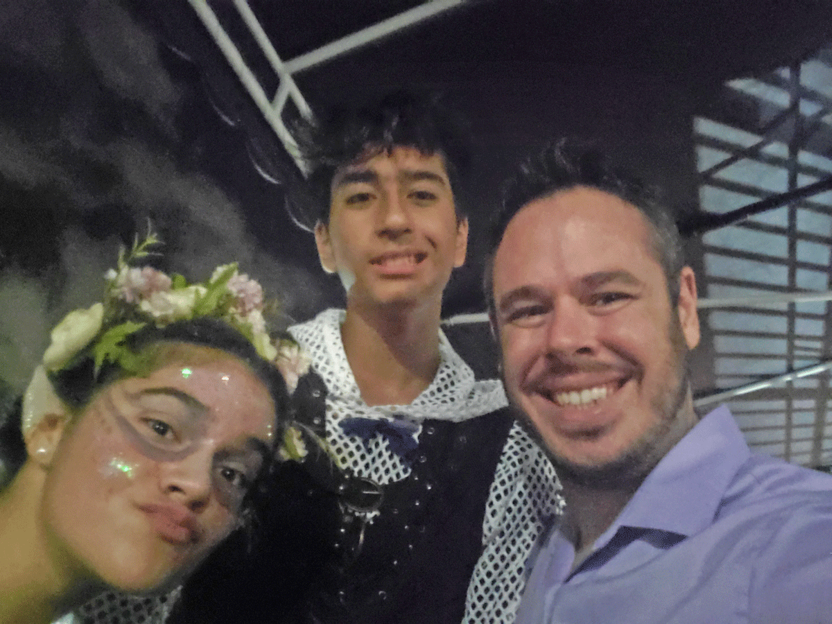 James Johnson is a Middle School English teacher, pictured here with students after a school theatre production.