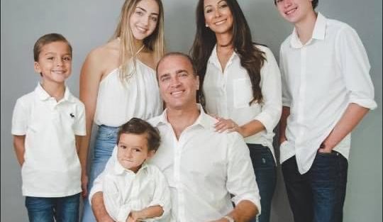 family smiling dressed in white