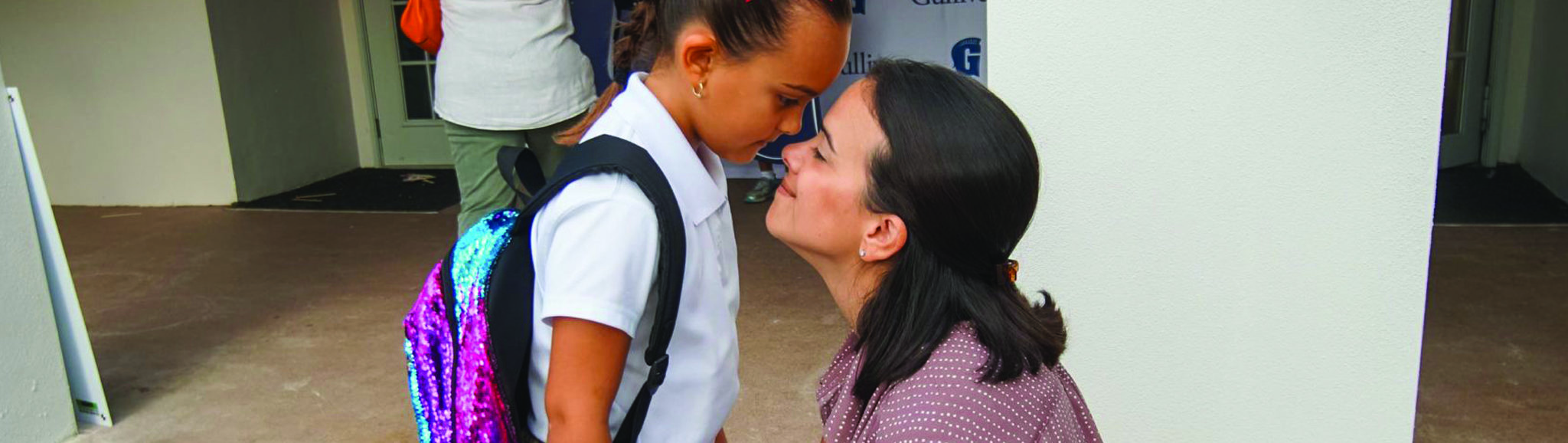 Mother daughter at school drop-off