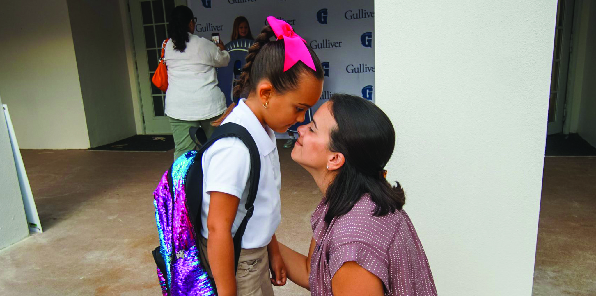 Mother daughter at school drop-off